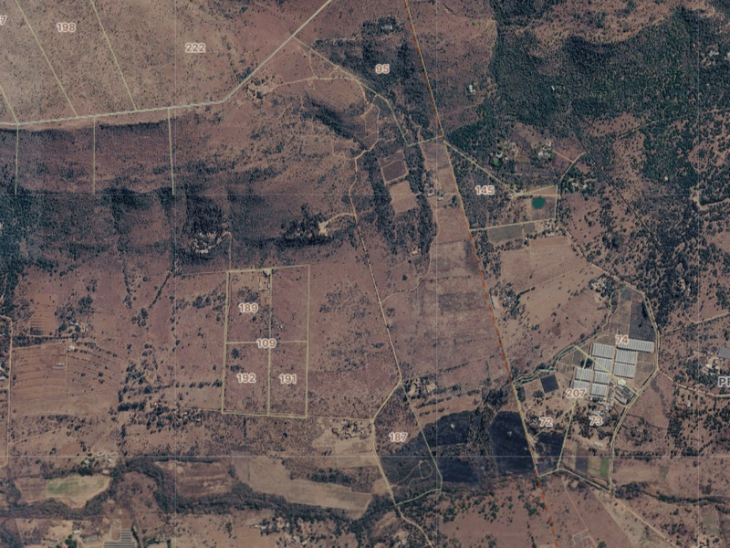An aerial satellite view showing the layout of various land parcels and cadastral boundaries in a rural farm area.