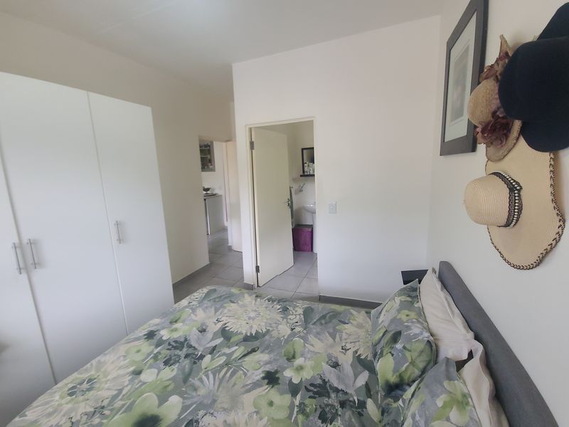 A bedroom featuring a built-in wardrobe and direct access to an adjoining bathroom.