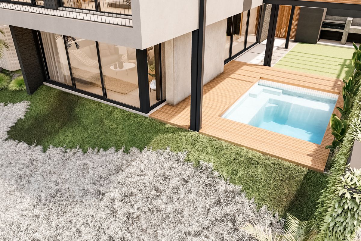 Aerial view of a modern property featuring a swimming pool with timber decking, landscaped garden, and a balcony with large sliding glass doors.