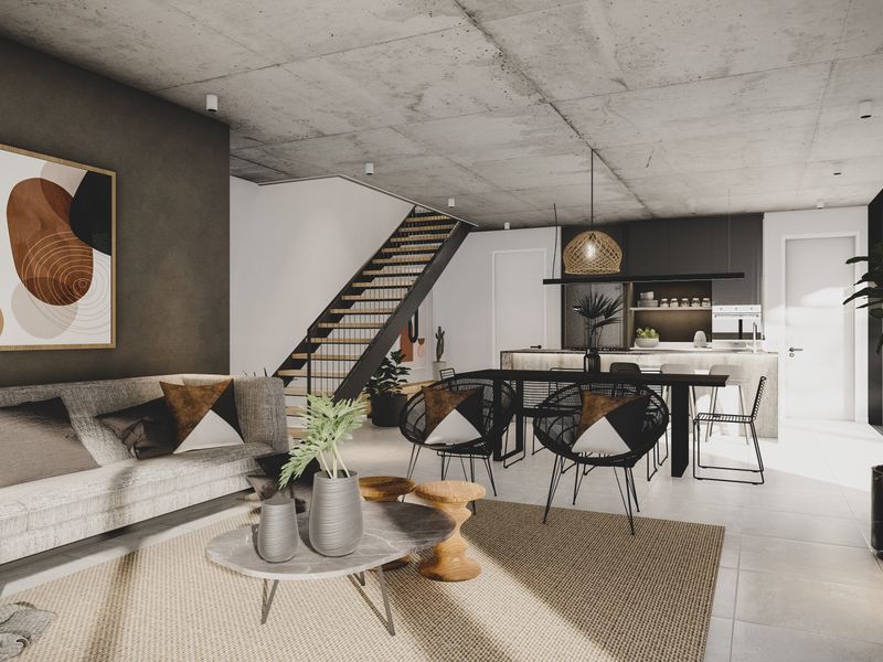Modern open-plan living and kitchen area featuring an exposed concrete ceiling, sleek cabinetry, and a contemporary staircase.