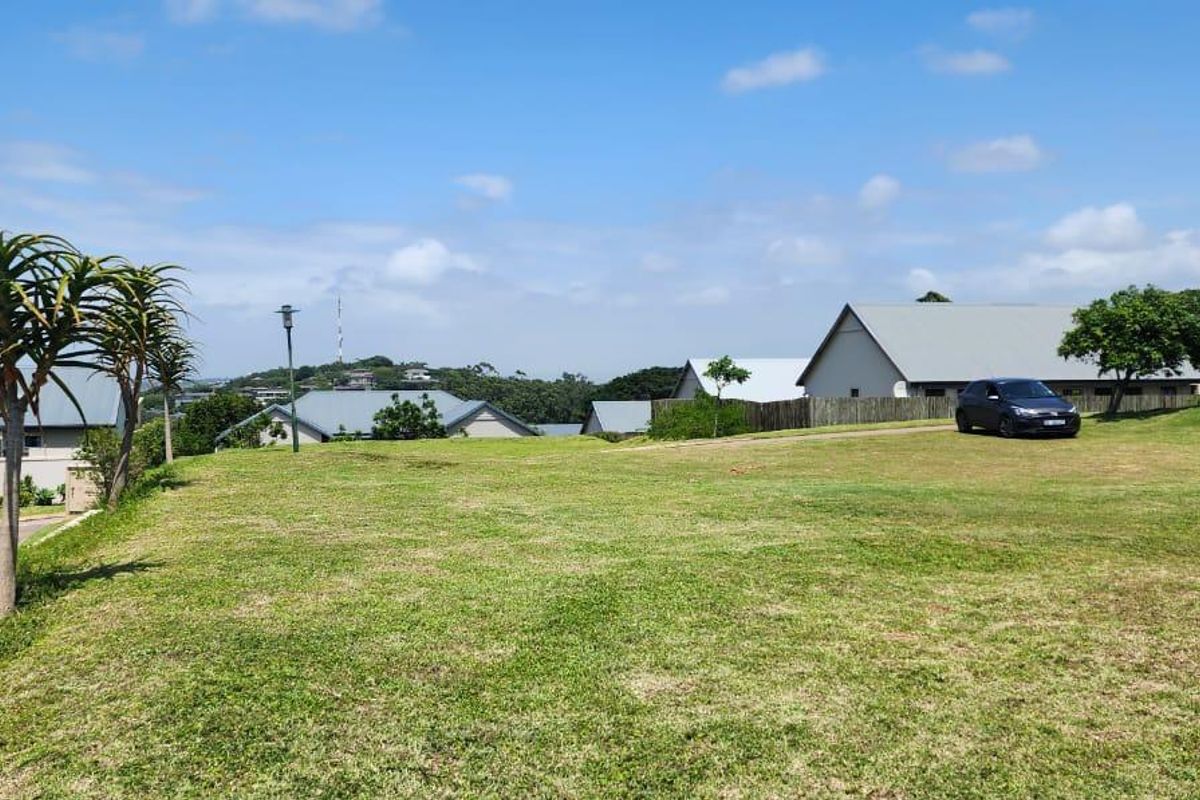 A spacious, well-maintained grassy plot situated within a residential estate, offering open views of the surrounding neighborhood and landscape.