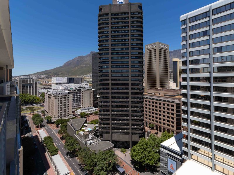Elevated urban view overlooking the city skyline and surrounding high-rise buildings with Table Mountain in the background.