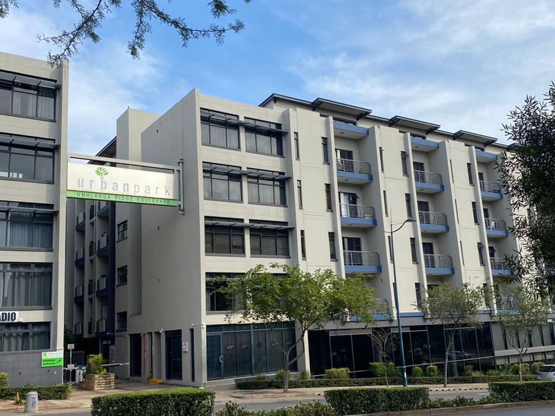 Exterior view of the Urban Park apartment complex, featuring modern multi-story architecture with balconies and street-level commercial frontage.