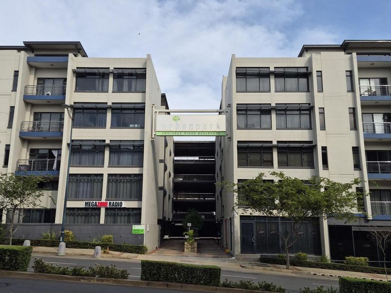 Exterior view of the Urban Park apartment complex on Umhlanga Ridge Boulevard, featuring modern multi-story architecture with balconies and street-level access.