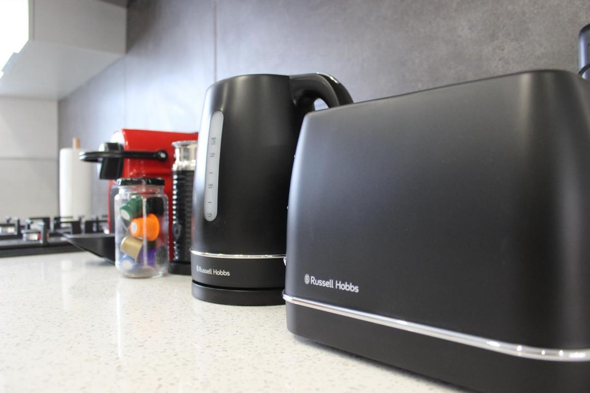 Close-up view of a modern kitchen countertop featuring a stone-look surface and integrated gas hob.