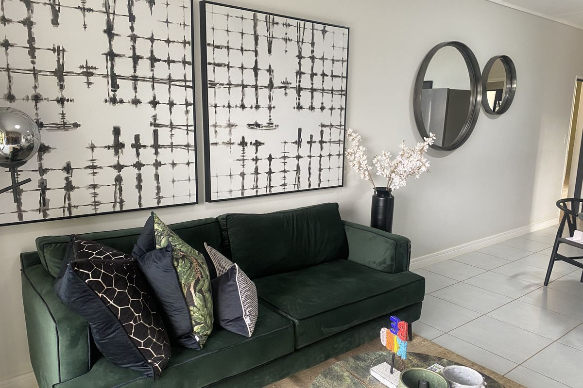 A well-maintained living room featuring neutral tiled flooring and clean wall finishes, providing a bright and inviting space.