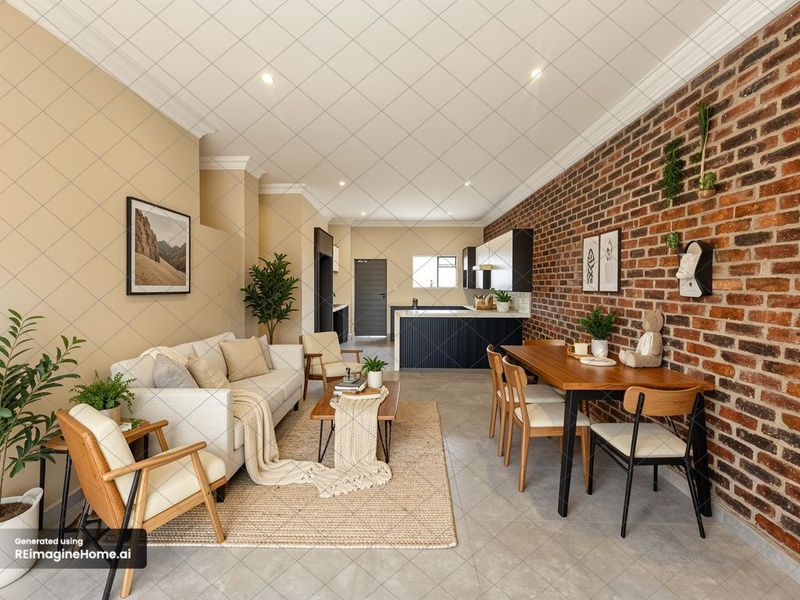 Spacious open-plan living and dining area featuring an exposed brick feature wall, modern kitchen cabinetry, and recessed lighting throughout.