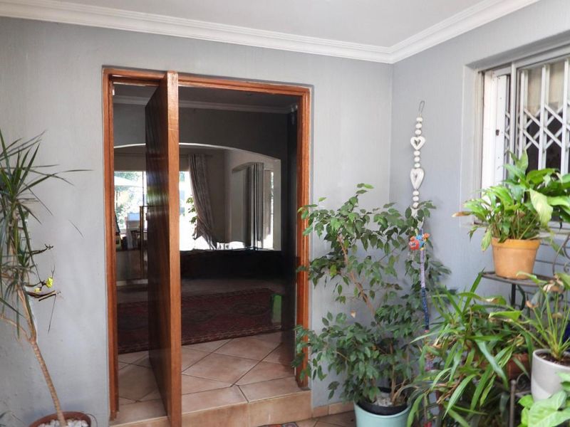 Entrance area featuring tiled flooring, a wooden door frame, and a view into the interior living space.