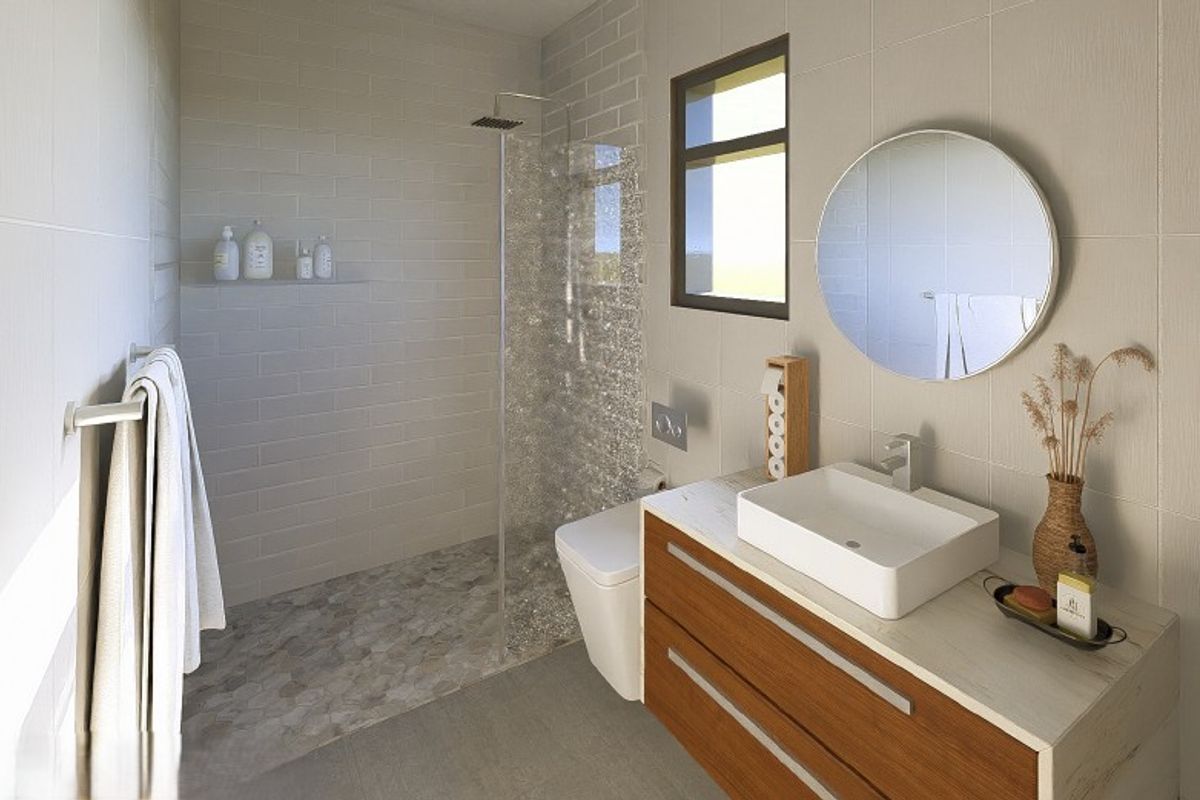 Modern bathroom featuring a walk-in shower with pebble flooring, wall-mounted toilet, and a contemporary vanity with a vessel sink.