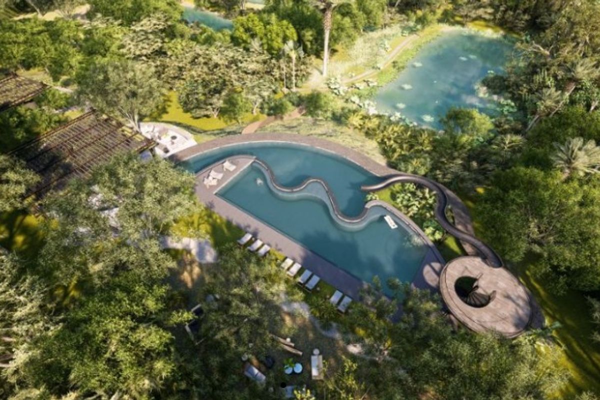 An aerial view of a luxury swimming pool complex set within a lush, landscaped garden environment with natural water features.