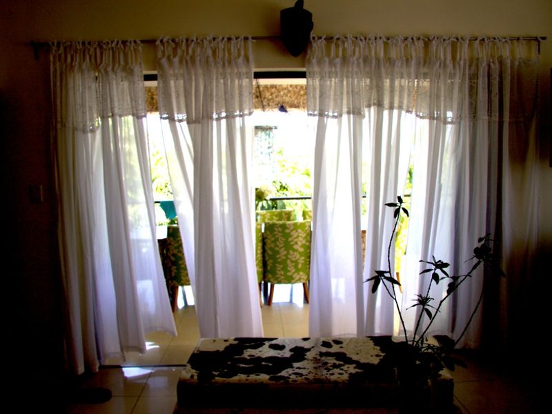 A view from an interior living space looking out through large sliding glass doors onto a covered patio area.
