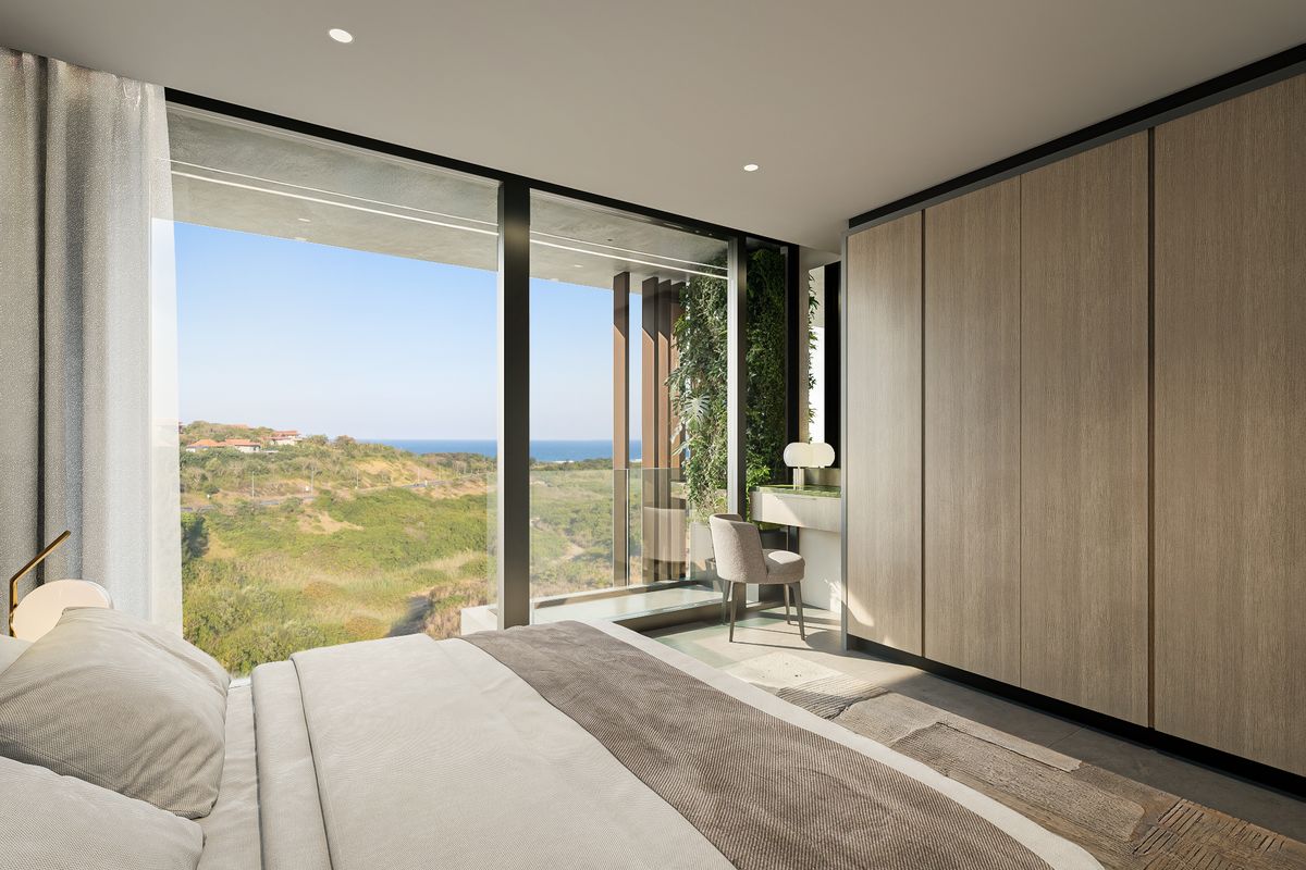 Modern bedroom featuring floor-to-ceiling windows with scenic coastal views, integrated built-in wardrobes, and high-end contemporary finishes.