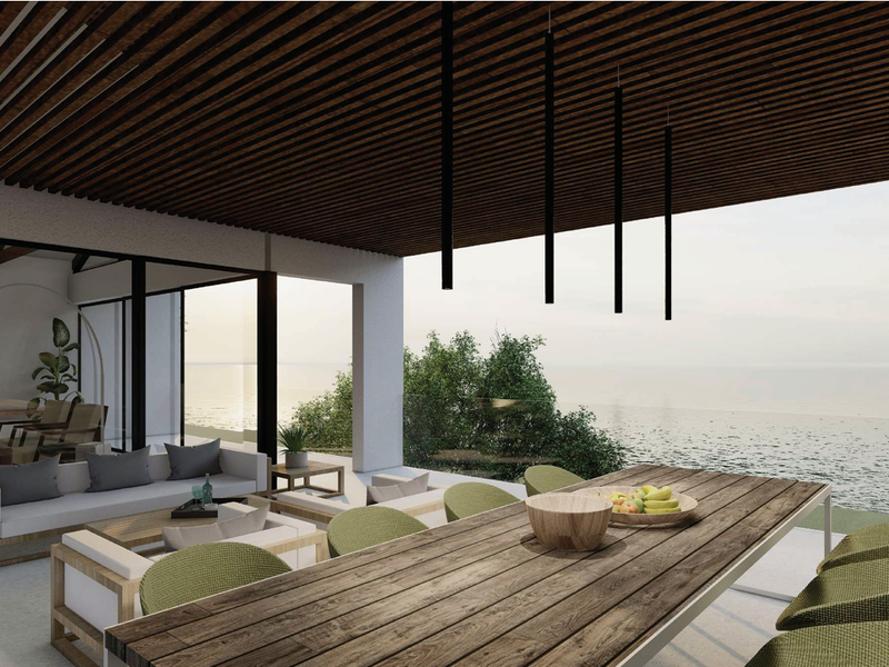 A modern covered patio featuring a slatted timber ceiling, glass balustrade, and expansive ocean views, perfect for outdoor dining and relaxation.