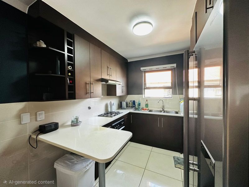 Modern kitchen featuring dark wood cabinetry, light stone countertops, a gas hob, integrated extractor, and a convenient breakfast nook with tiled flooring.