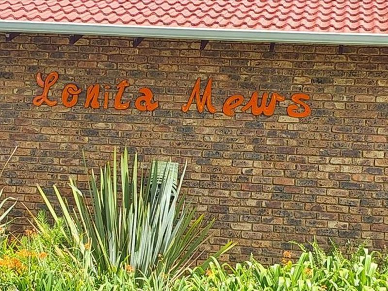 Exterior view of the Lonita Mews complex featuring a classic face brick facade and a tiled roof.