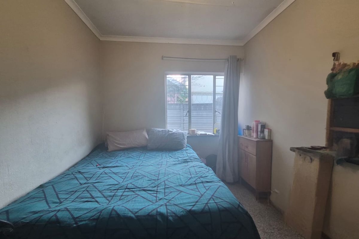 A compact bedroom featuring a window with a curtain rail and coving, requiring cosmetic updates to improve the overall finish and appeal.