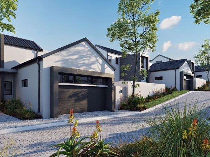 A modern cluster home exterior featuring a paved driveway, integrated garage, and contemporary architectural design within a landscaped residential estate.