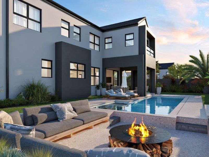 Rear exterior view of a modern cluster home featuring a swimming pool, sunken fire pit area, and a landscaped garden.