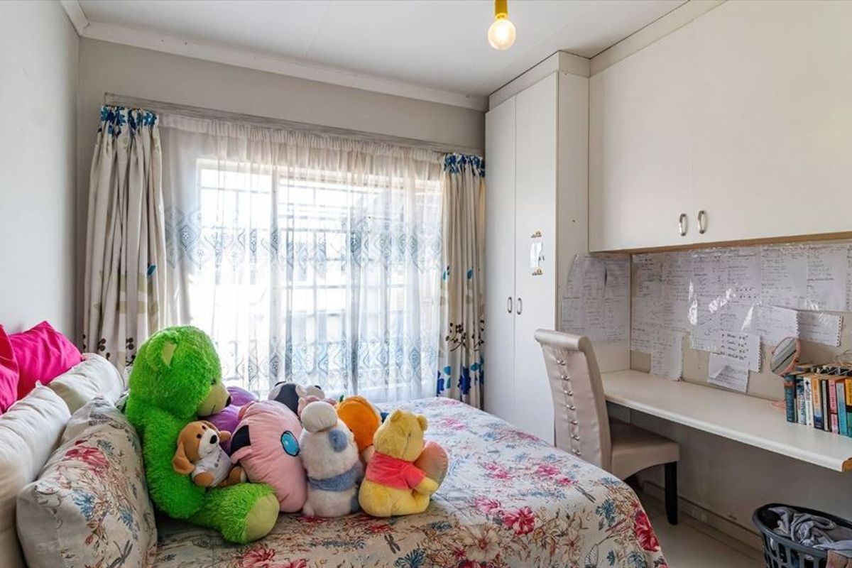 A bedroom featuring built-in cupboards and a integrated desk area, providing functional storage and workspace.
