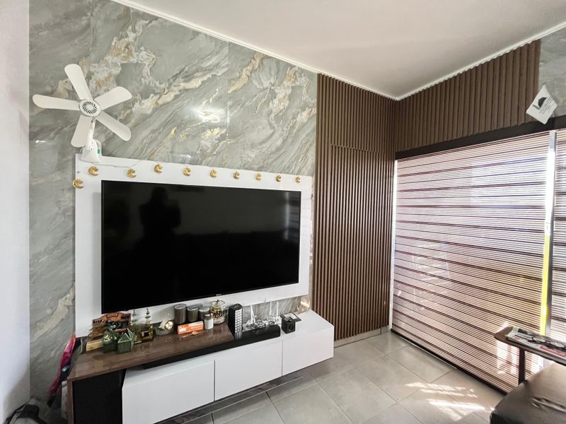 Living room featuring a modern marble-effect feature wall, vertical timber slat paneling, and tiled flooring with integrated roller blinds.
