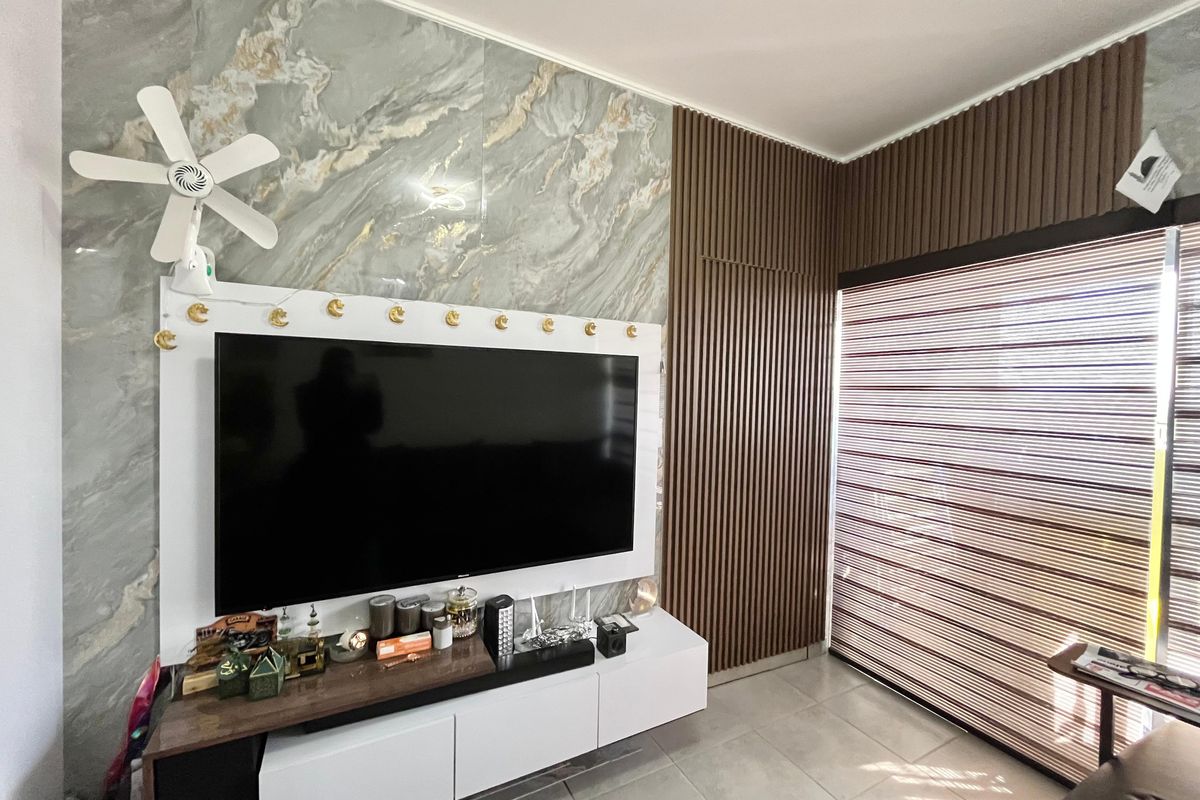 Living room featuring a modern marble-effect feature wall, vertical timber slat paneling, and tiled flooring with integrated roller blinds.