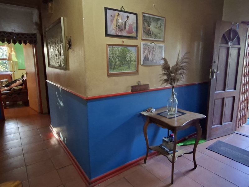 Entrance hallway featuring tiled flooring and direct access to the exterior, providing a functional transition space within the home.