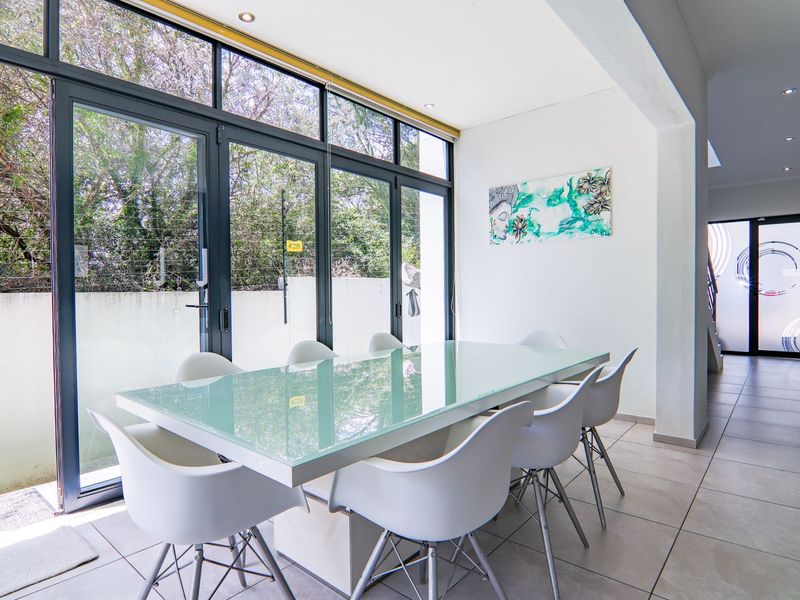 Bright dining area featuring large glass sliding doors that provide ample natural light and direct access to the outdoor space.
