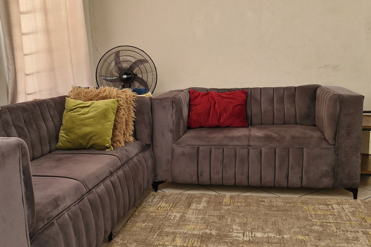 A living room area featuring tiled flooring and neutral wall finishes, providing a functional space for relaxation.