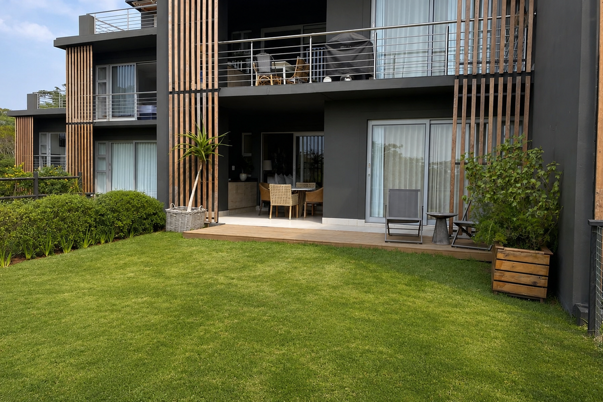 Modern apartment rear elevation featuring a private timber deck, landscaped garden, and contemporary architectural timber screening with balcony access.