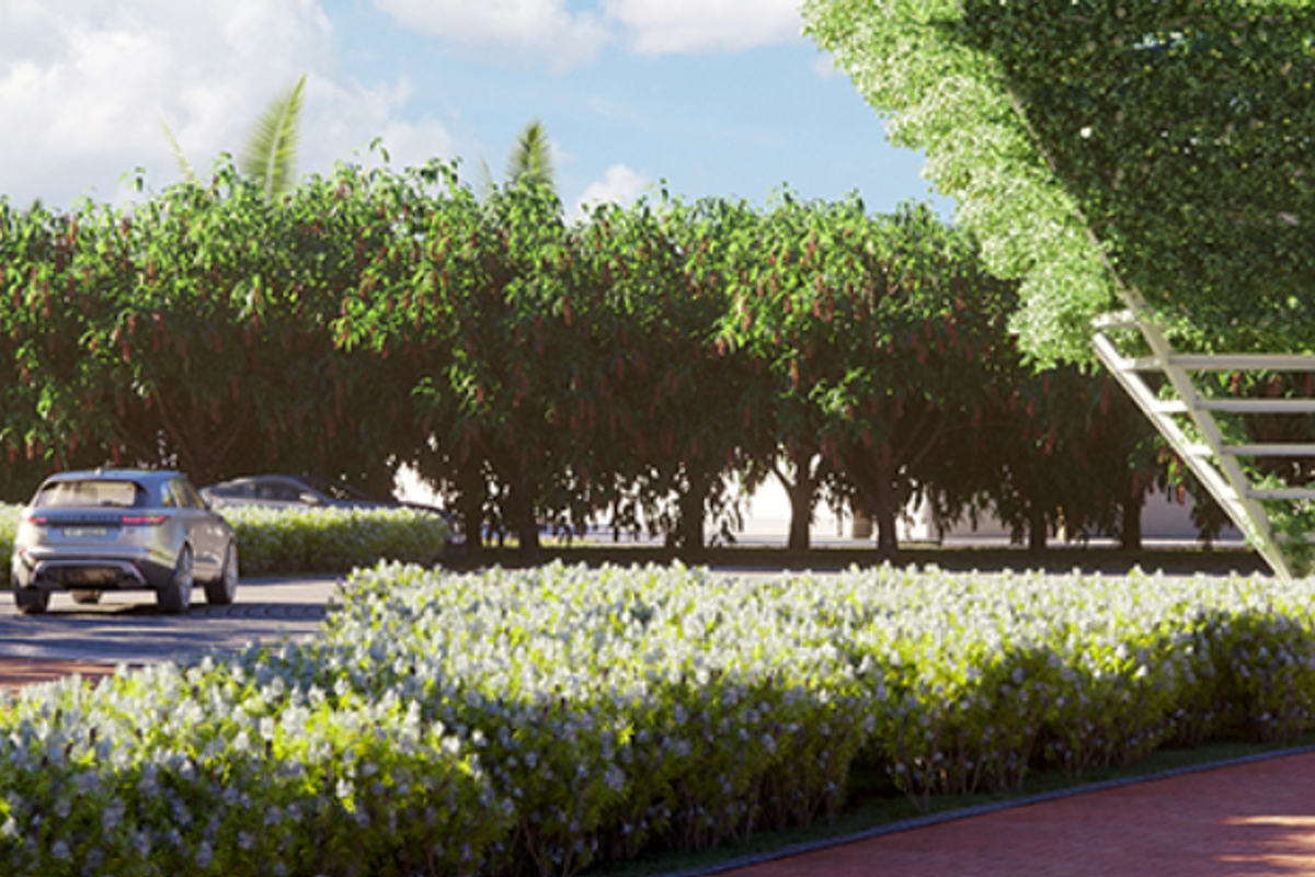 A beautifully landscaped garden area featuring mature trees, lush banana plants, manicured shrubbery, and paved walking paths.