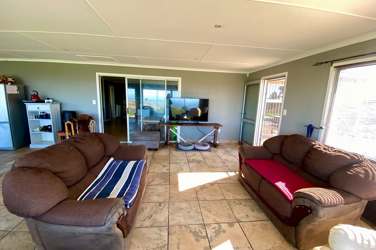 Spacious living room featuring tiled flooring, recessed lighting, and sliding glass doors providing access to the exterior and natural light.