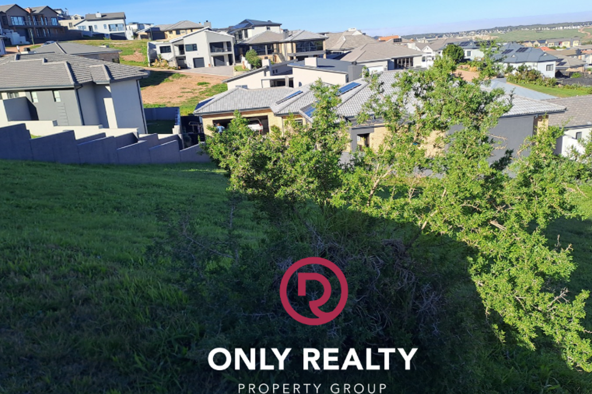 A view of the sloped residential land parcel overlooking the surrounding neighborhood and established housing development.