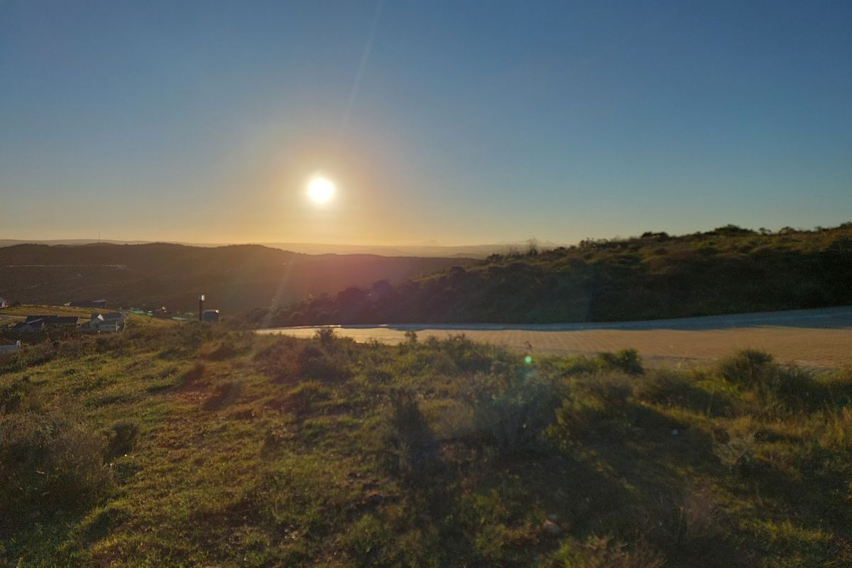 A scenic sunset view overlooking the rolling hills and landscape of the vacant residential property.