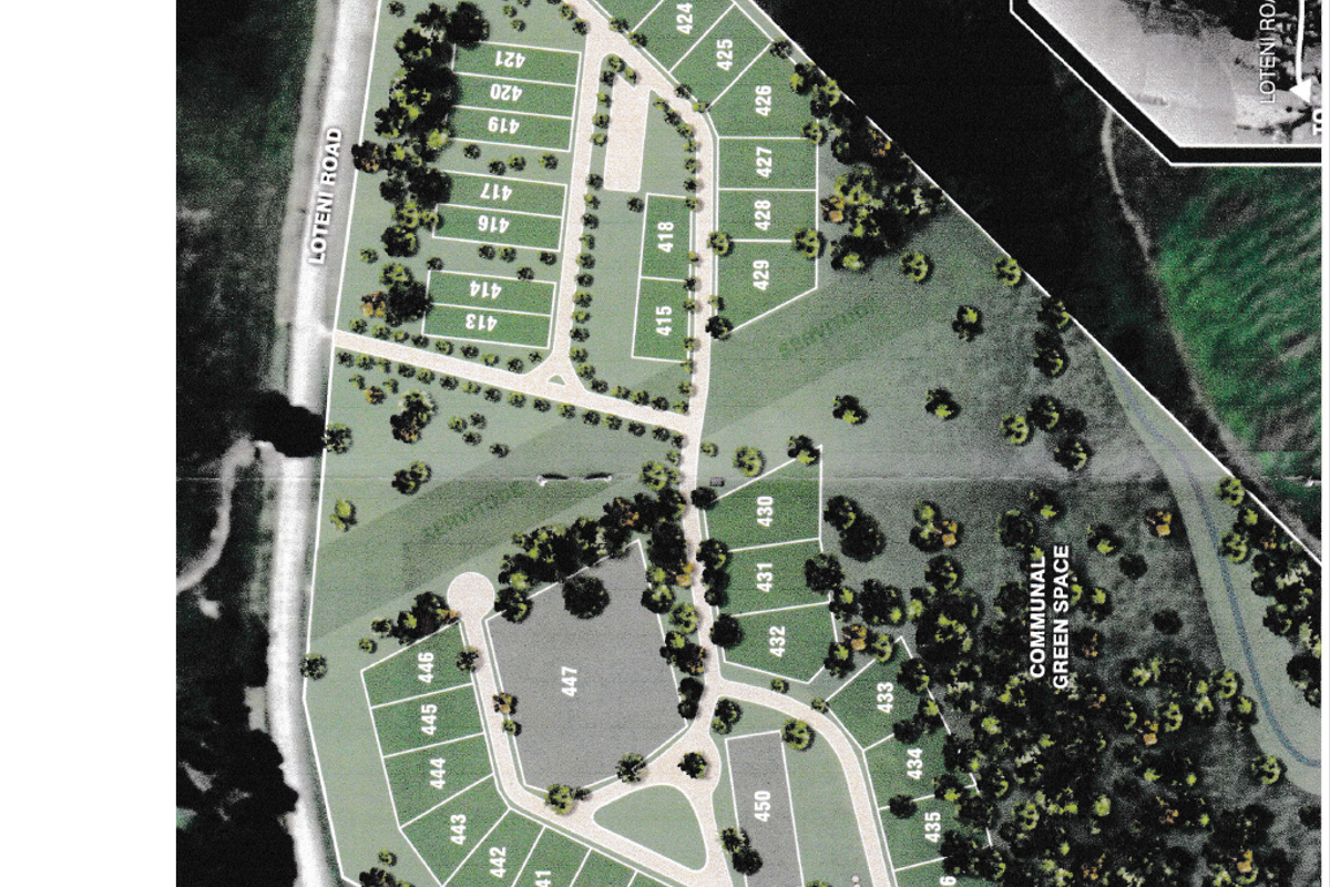 A detailed site development plan showing the layout of residential plots, internal roads, and communal green spaces within the estate.