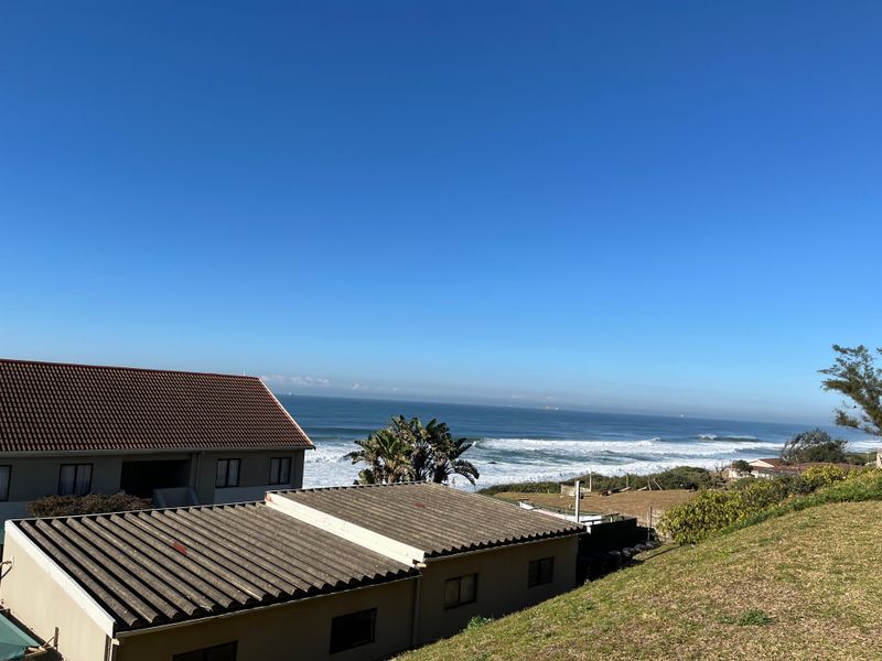 A clear, elevated view of the ocean and coastline from the property, showcasing the coastal location and surrounding landscape.