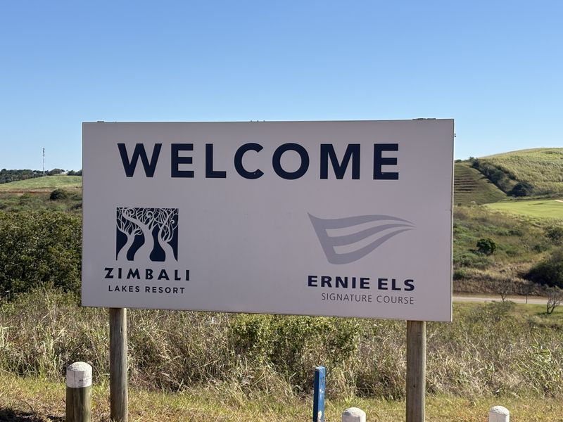 A welcome sign for Zimbali Lakes Resort and the Ernie Els Signature Course, situated in a scenic residential estate setting.
