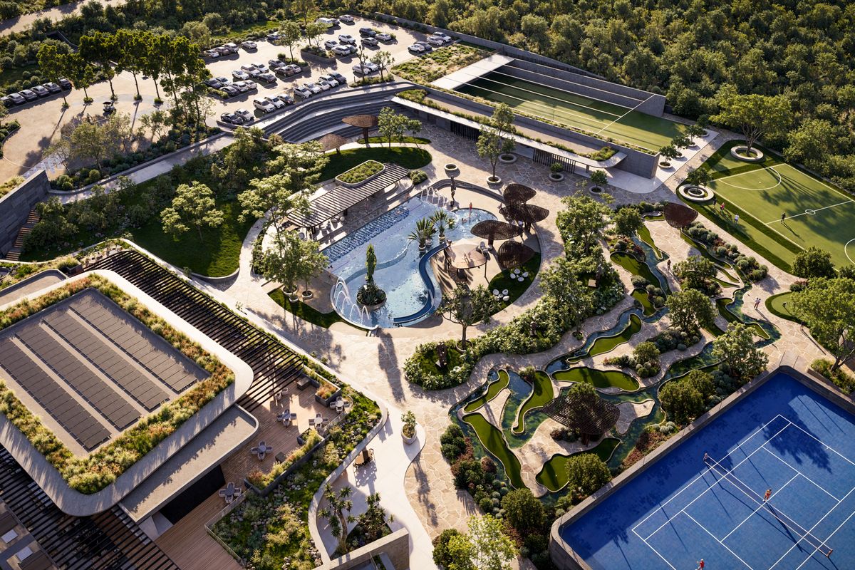 Aerial view of a luxury residential estate featuring a swimming pool, tennis court, soccer field, landscaped gardens, and extensive parking facilities.