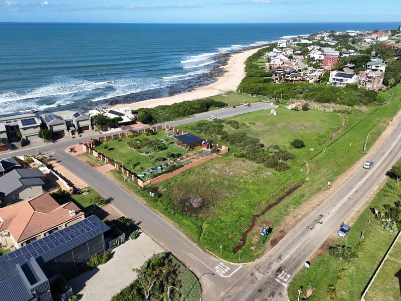 Aerial view of a prime coastal vacant residential plot situated on a corner, offering proximity to the beach and established neighborhood infrastructure.