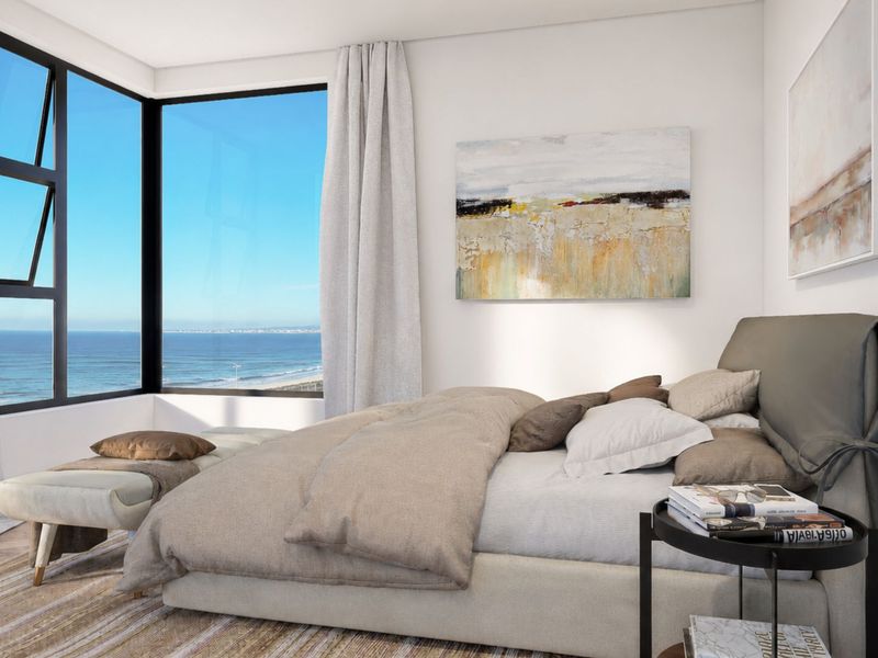 A modern bedroom featuring herringbone flooring and a large corner window offering expansive ocean views.
