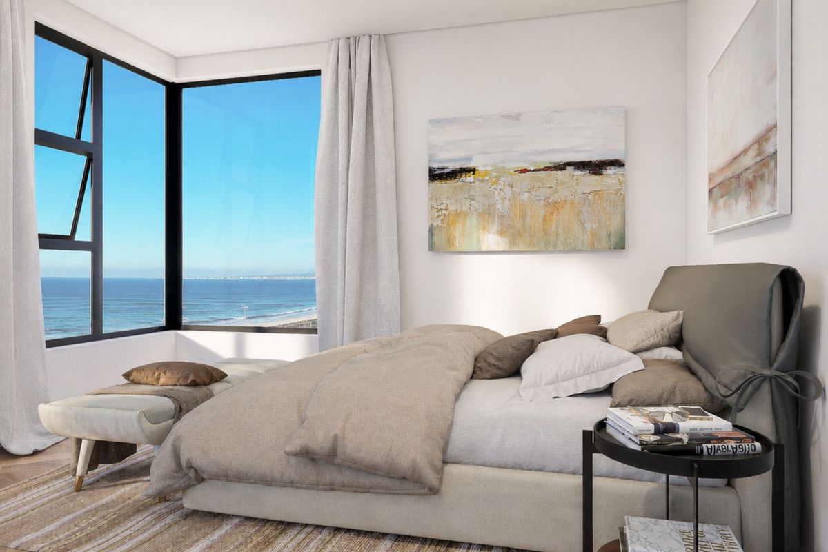 A modern bedroom featuring herringbone flooring and a large corner window offering expansive ocean views.