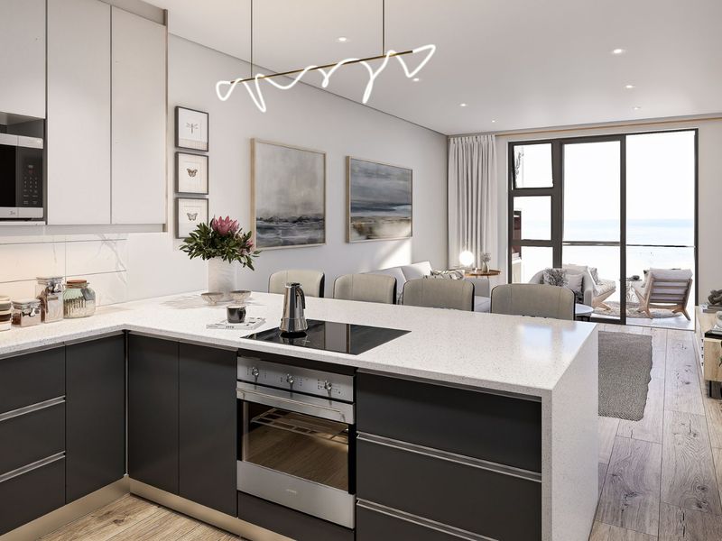 Modern open-plan kitchen and living area featuring sleek cabinetry, integrated appliances, stone countertops, and seamless access to a balcony with ocean views.