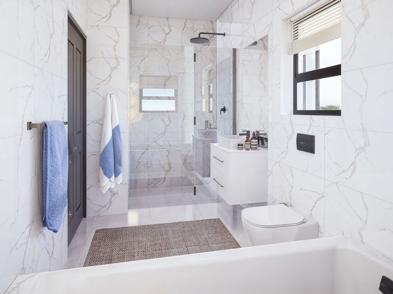 Modern bathroom featuring marble-look wall tiles, a wall-hung vanity with vessel sink, wall-mounted toilet, and a spacious glass-enclosed shower with black fixtures.