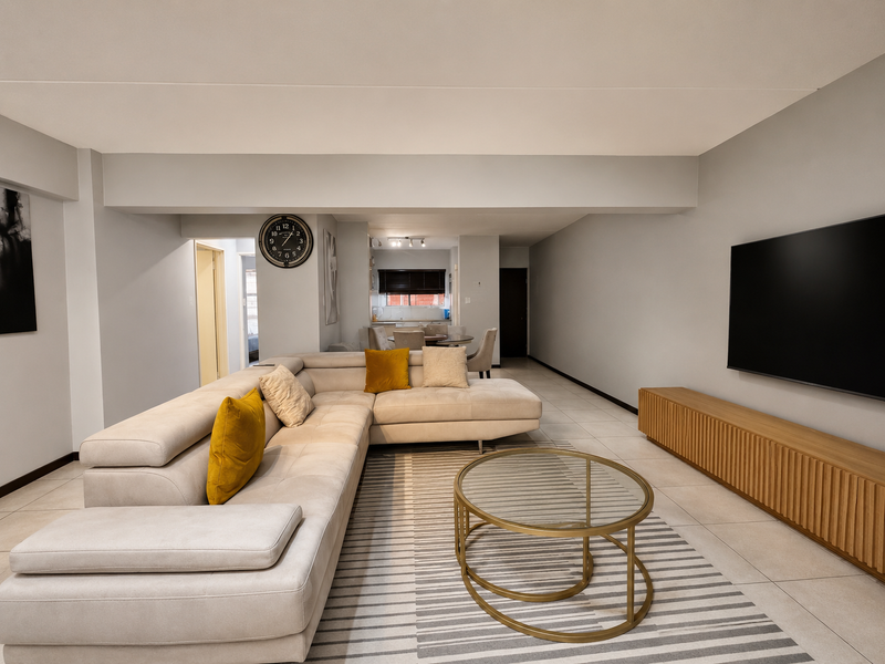 Spacious open-plan living area featuring neutral tiled flooring and a modern layout that flows seamlessly into the dining and kitchen space.