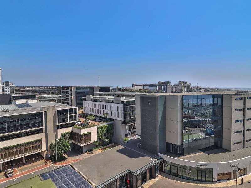 An elevated urban view overlooking surrounding commercial buildings and modern apartment complexes in a developed city area.
