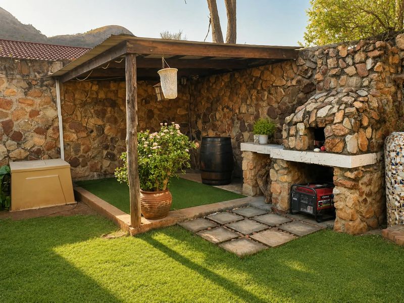 Outdoor entertainment area featuring a rustic stone-clad built-in fireplace, timber pergola, and paved patio space, ideal for alfresco dining and relaxation.