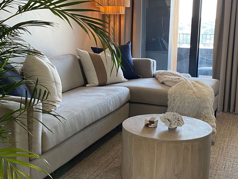 A comfortable living room area featuring large sliding glass doors that provide natural light and access to an outdoor space.