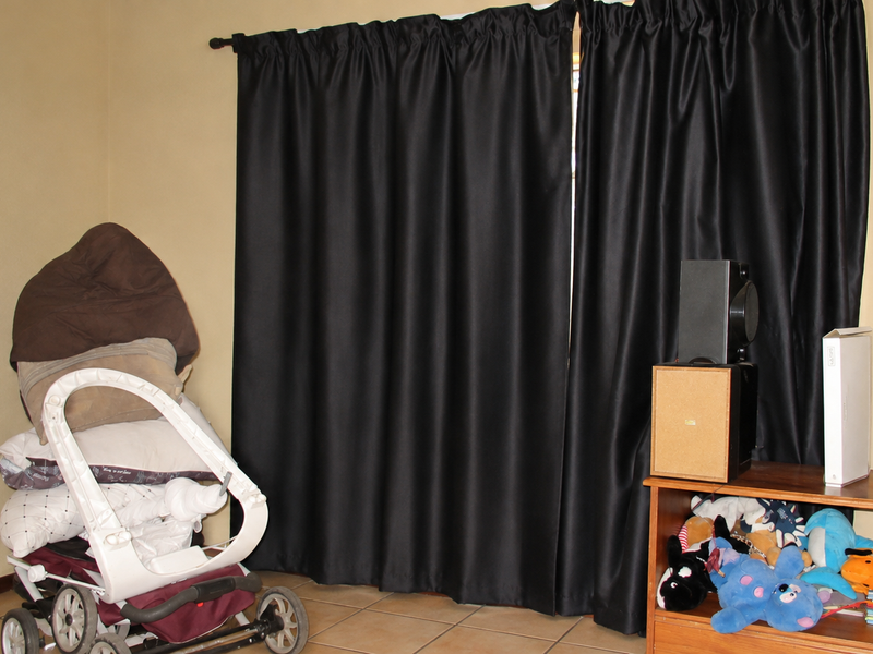 A bedroom space featuring tiled flooring and a curtain rod, providing a neutral foundation for interior design updates.