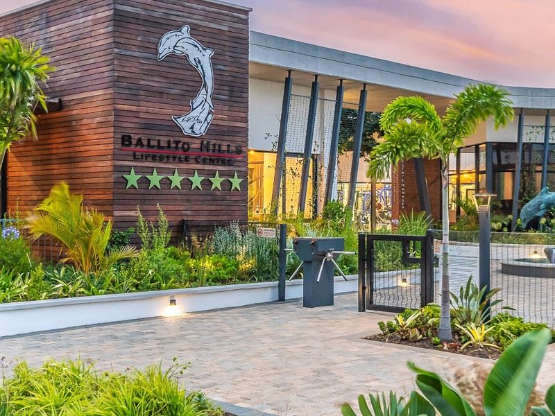 The modern entrance to the Ballito Hills Lifestyle Centre, featuring timber cladding, paved pathways, and well-maintained landscaping.