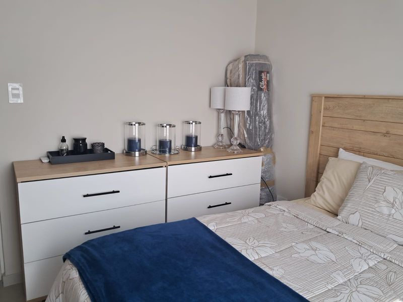 A well-maintained bedroom featuring neutral wall tones and a clean, functional layout.
