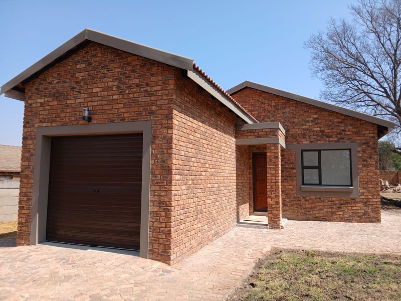 Modern face brick house featuring a single garage, paved driveway, and neat architectural finishes.